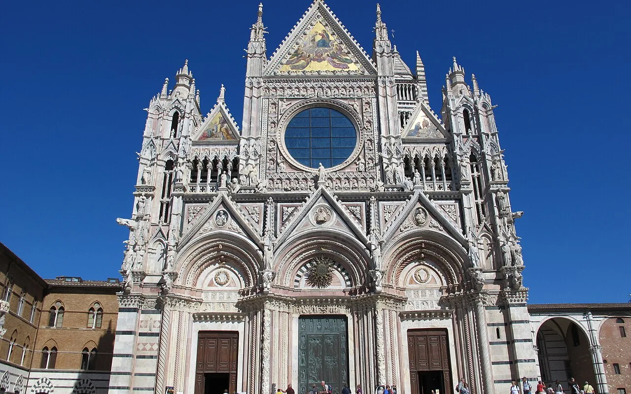 The marble façade of Siena Cathedral on Piazza del Duomo