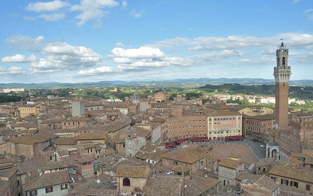 Siena's rooftops, Piazza del Campo and the Torre del Mangia seen from high above the city